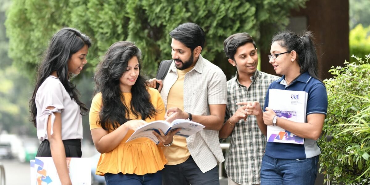 A group of diverse college students engaged in outdoor group study session, sharing books and ideas.